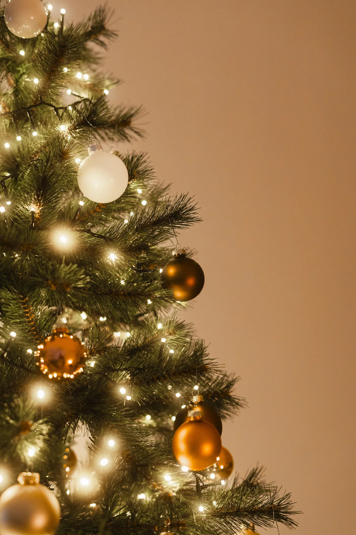 A decorated christmas tree with warm lights and ornaments