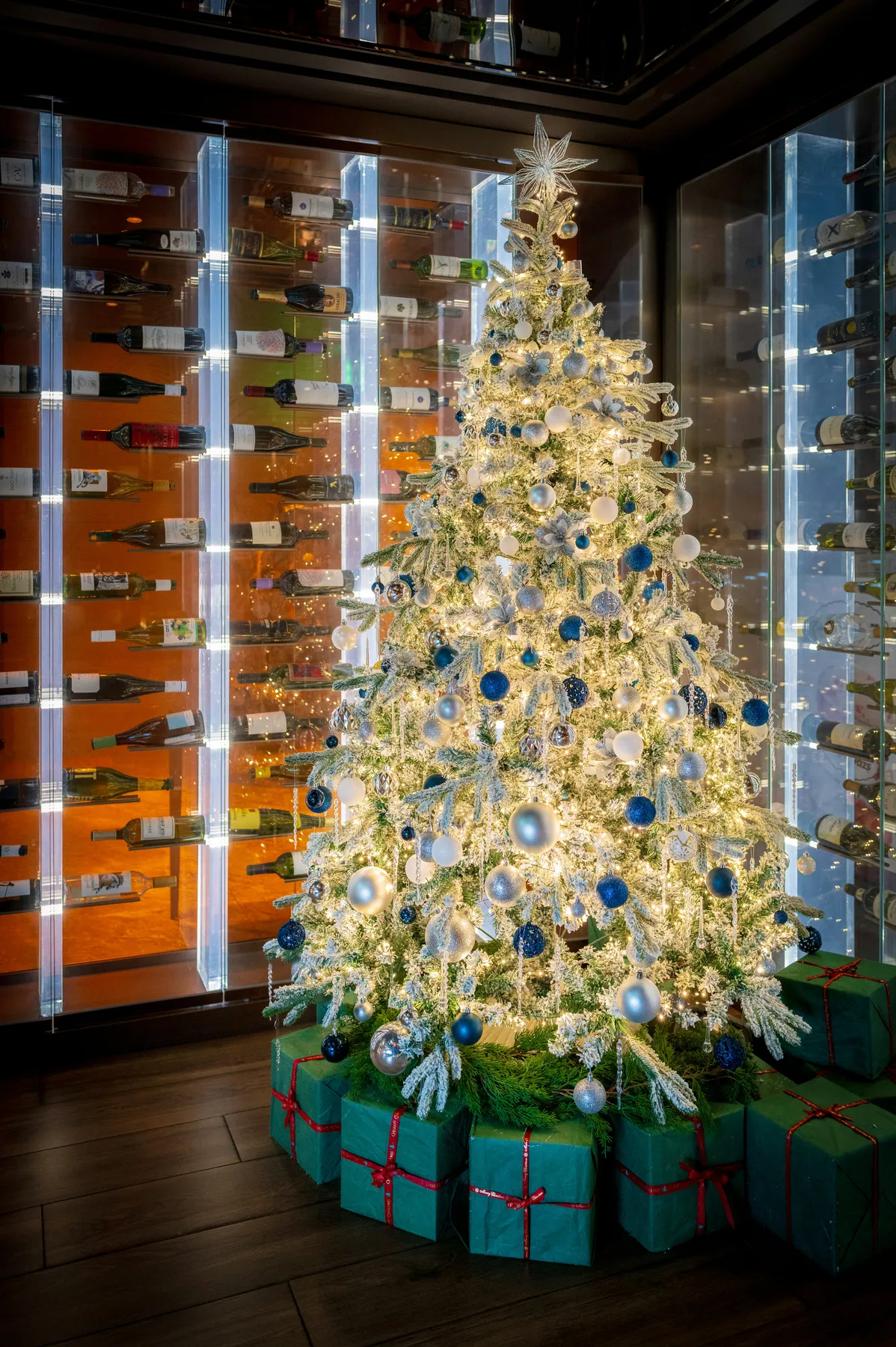 A decorated white christmas tree with gifts