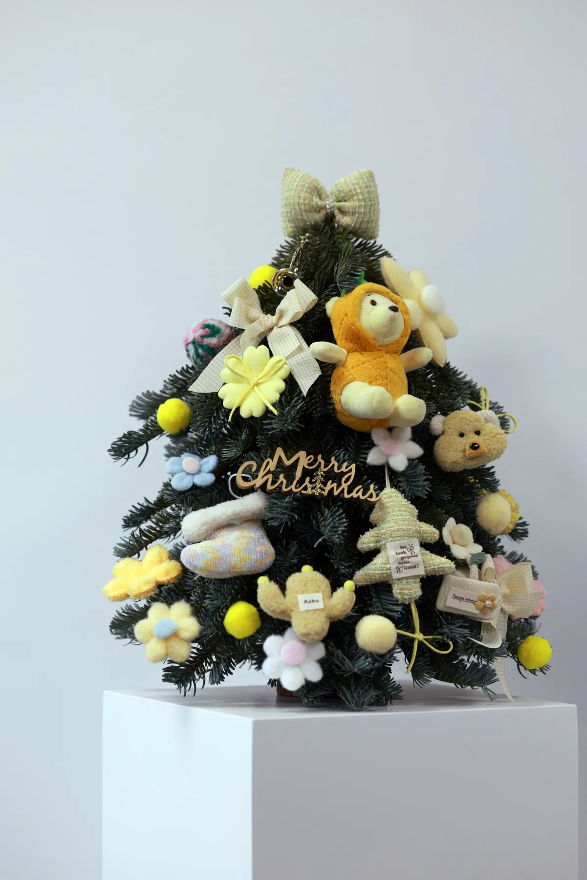 A delightful Christmas tree adorned with cute plush toys and holiday ornaments, perfect for festive decor.