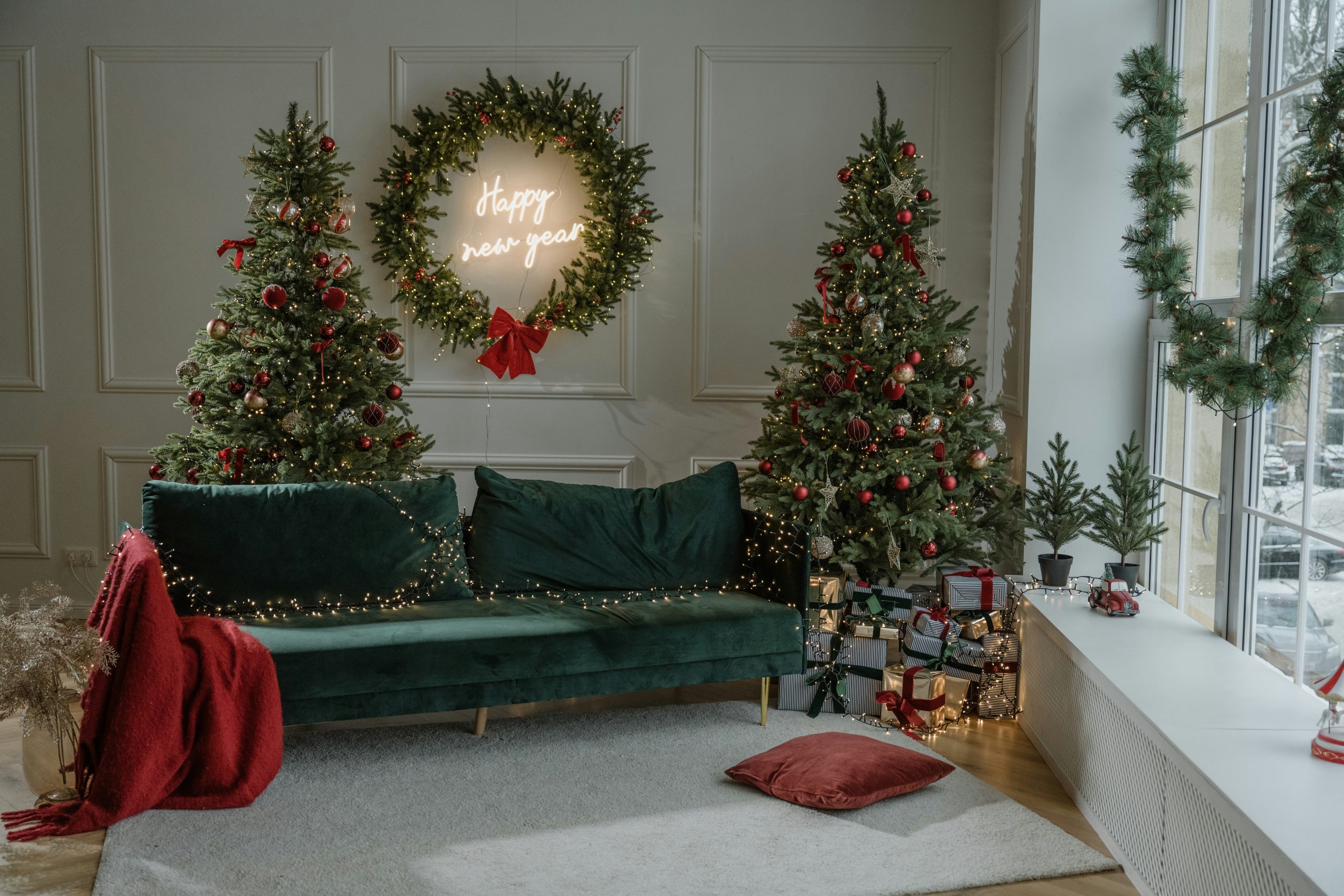 a living room decorated for christmas with wreaths on the wall