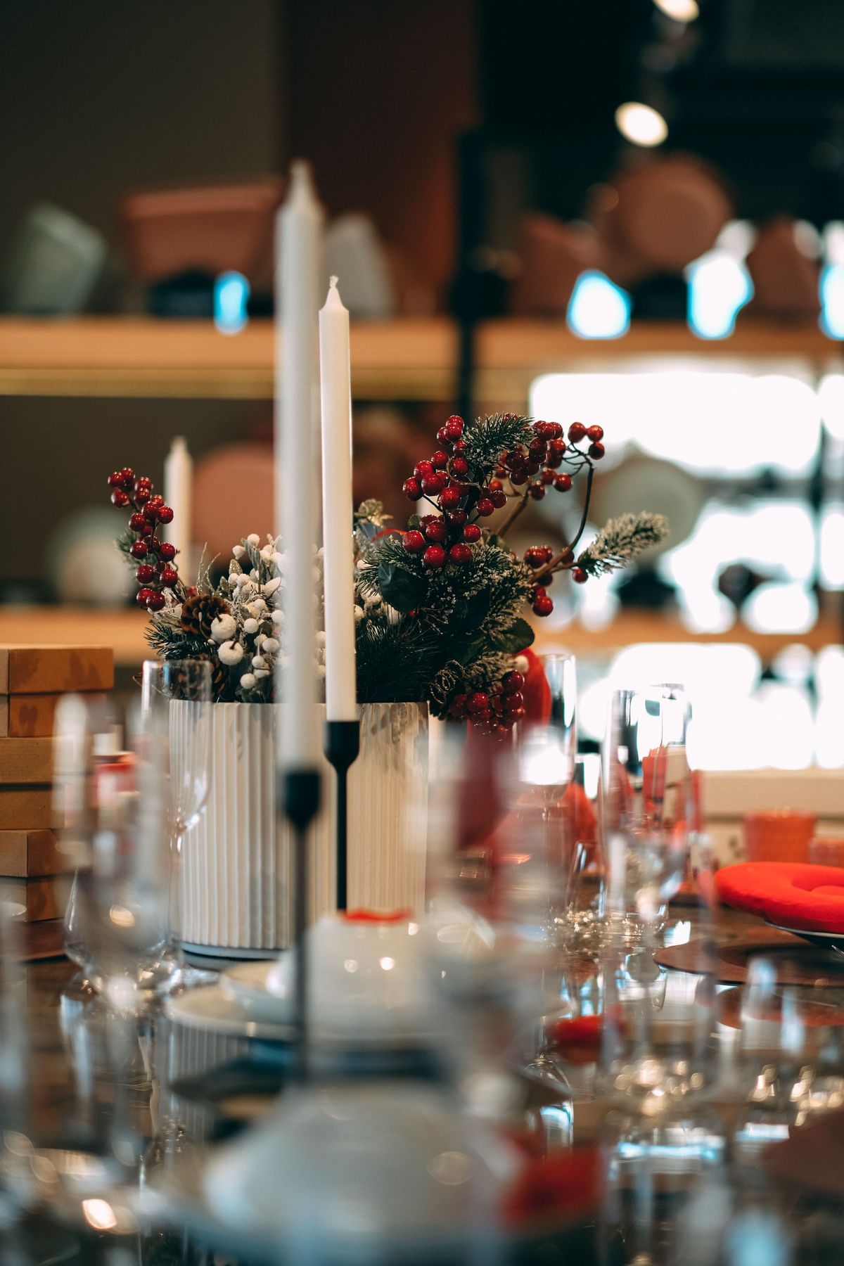 A refined table arrangement featuring candles and festive floral centerpiece, perfect for celebrations.