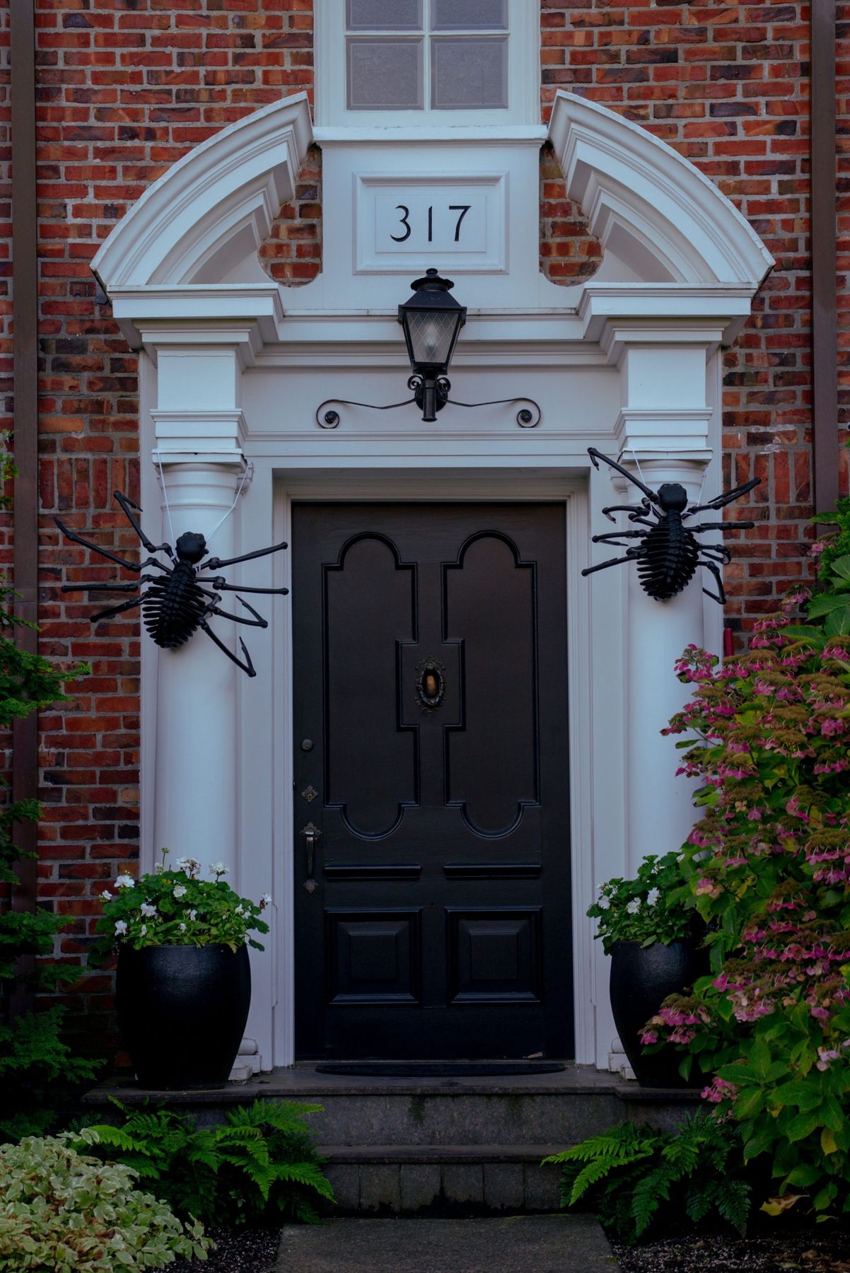 A spooky Halloween decorated doorway with spider decorations in a Seattle home.