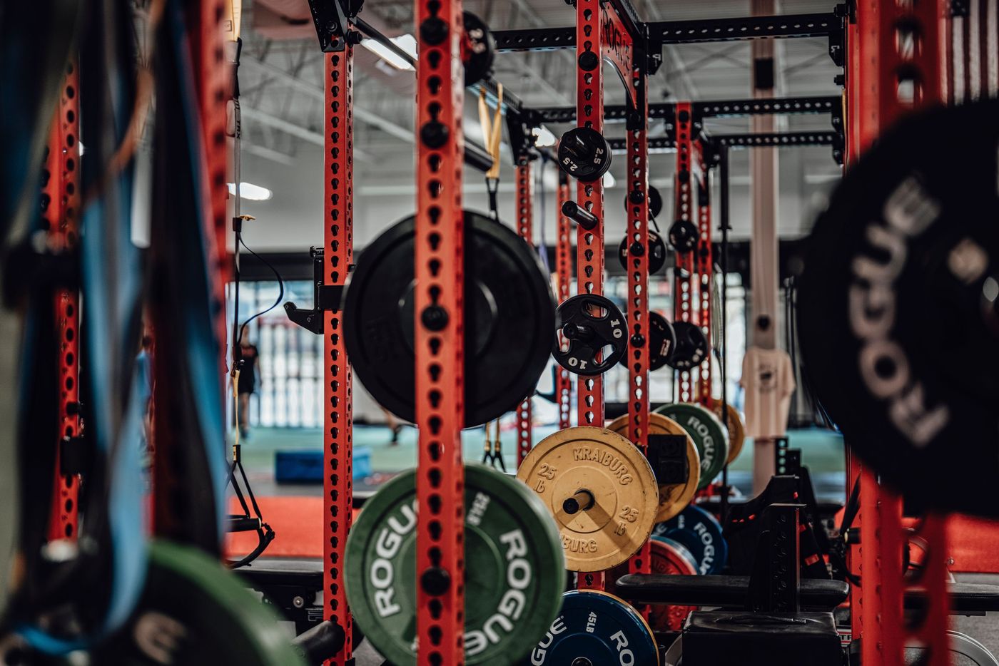 A well-equipped gym with various weightlifting gear and exercise equipment.