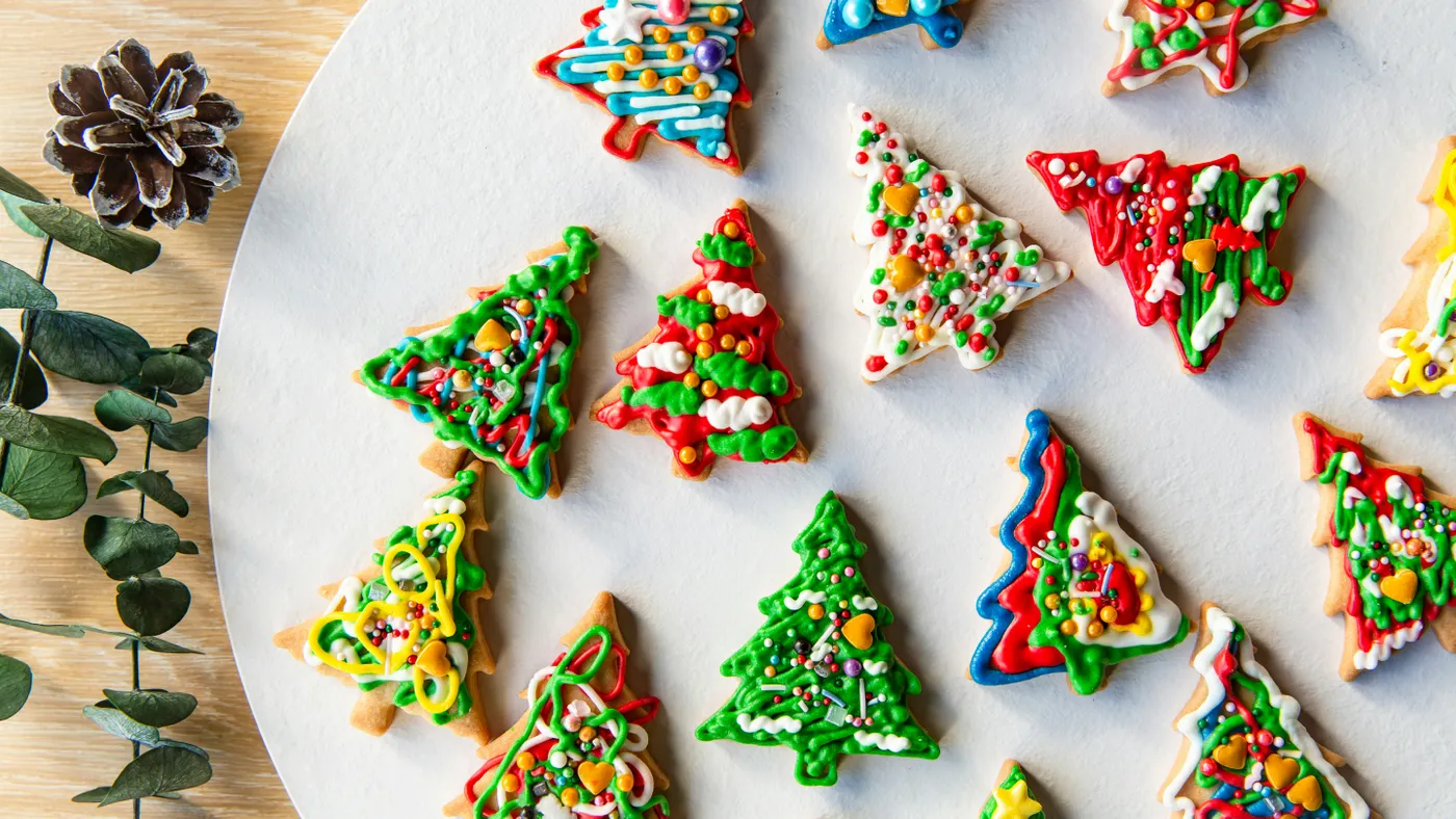 a white plate topped with lots of decorated cookies