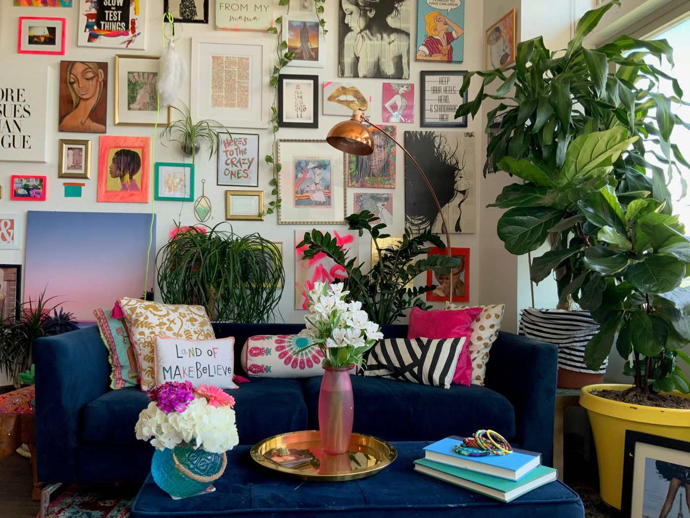 An eclectic gallery wall in a colorful maximalist apartment home in Denver, Colorado 