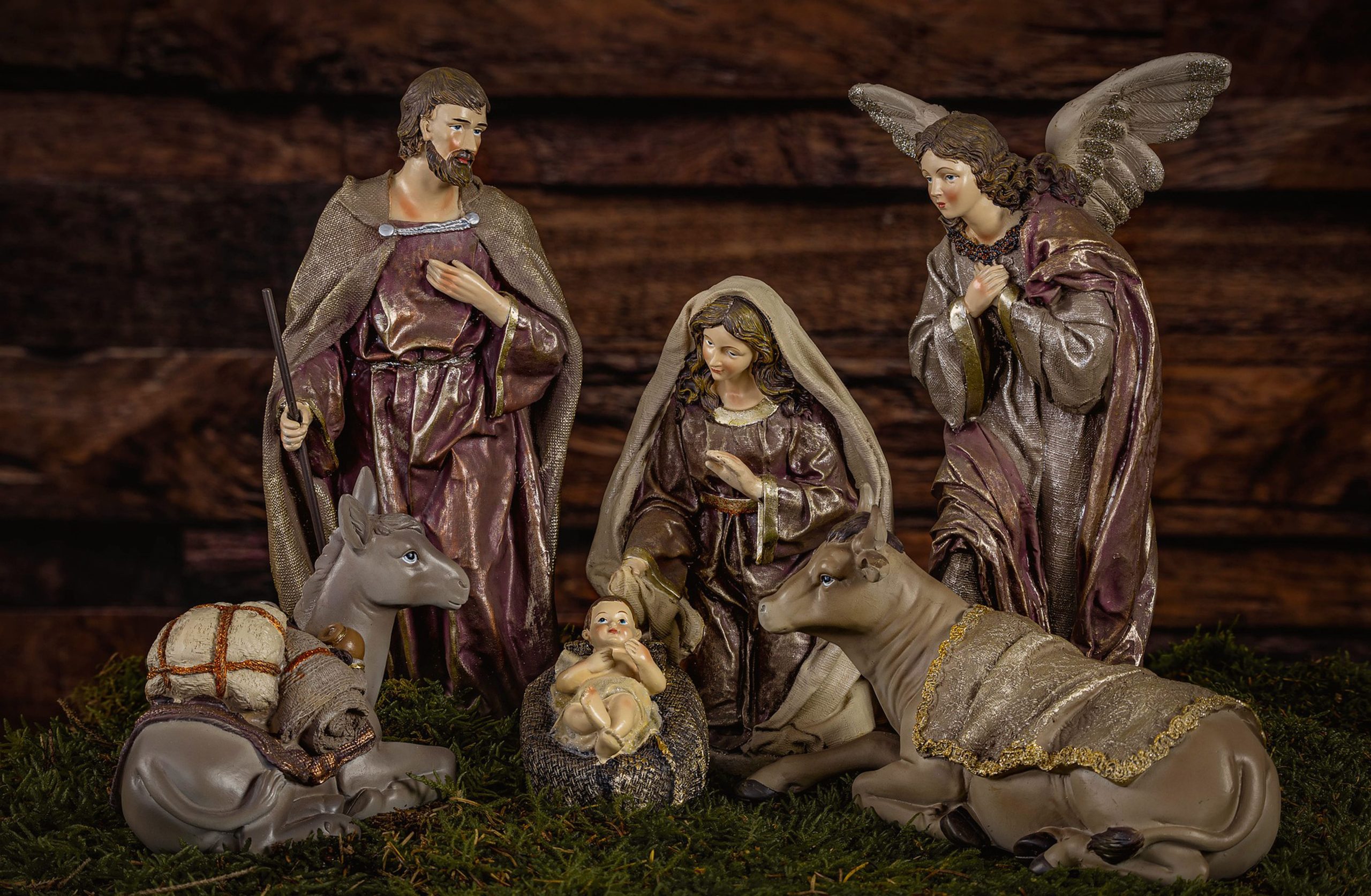 Artistic depiction of the Nativity scene featuring baby Jesus, Mary, Joseph, and angels.