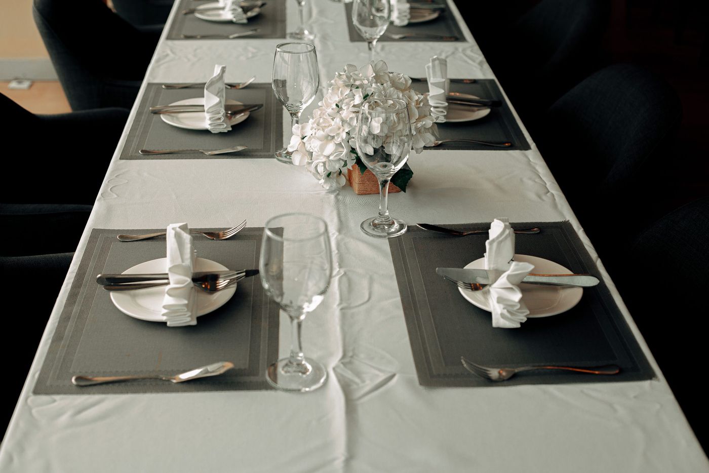 Beautifully arranged formal dining table with elegant tableware and floral centerpiece.