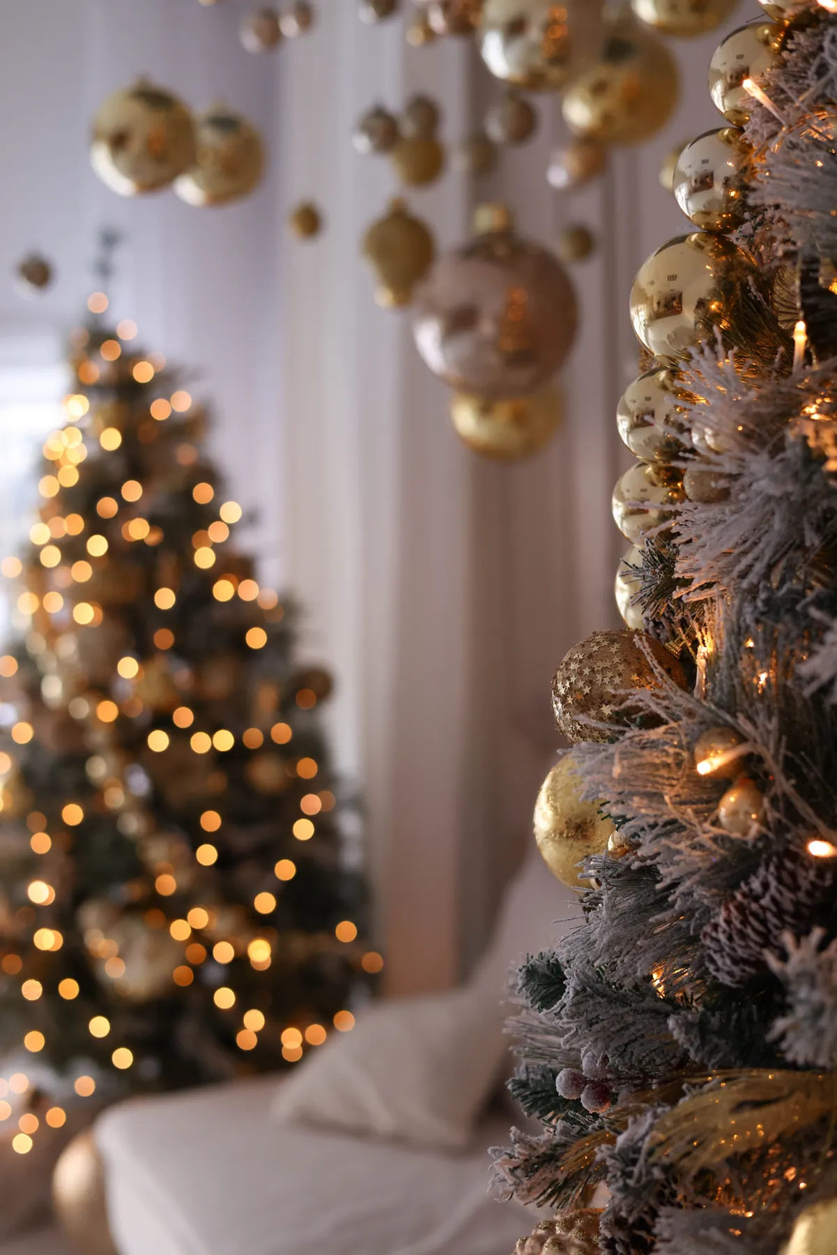 Beautifully decorated Christmas tree with golden baubles and lights for a festive holiday ambiance.