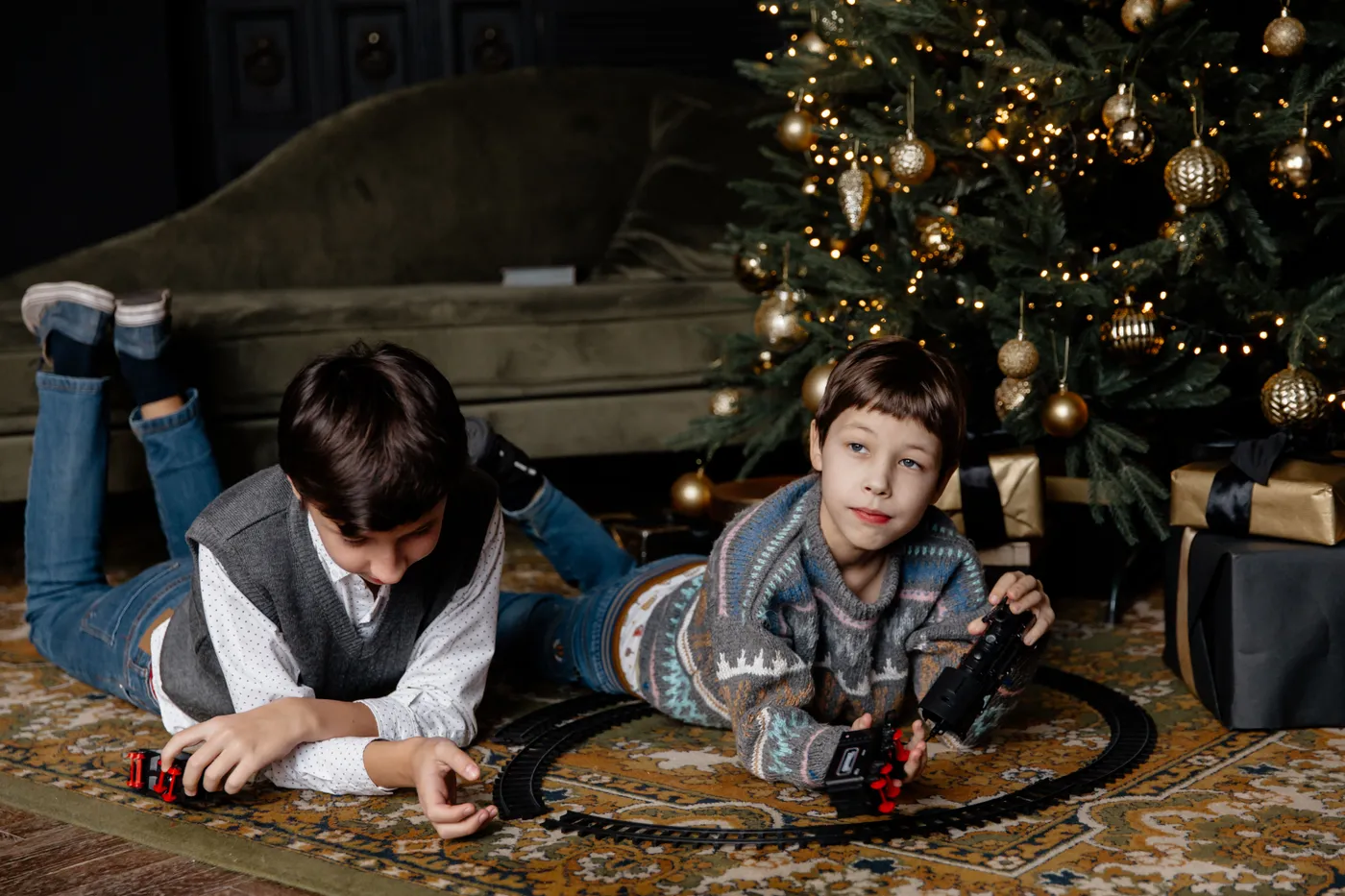 Boys Playing with a Toy Train under a Christmas Tree · Free Stock Photo