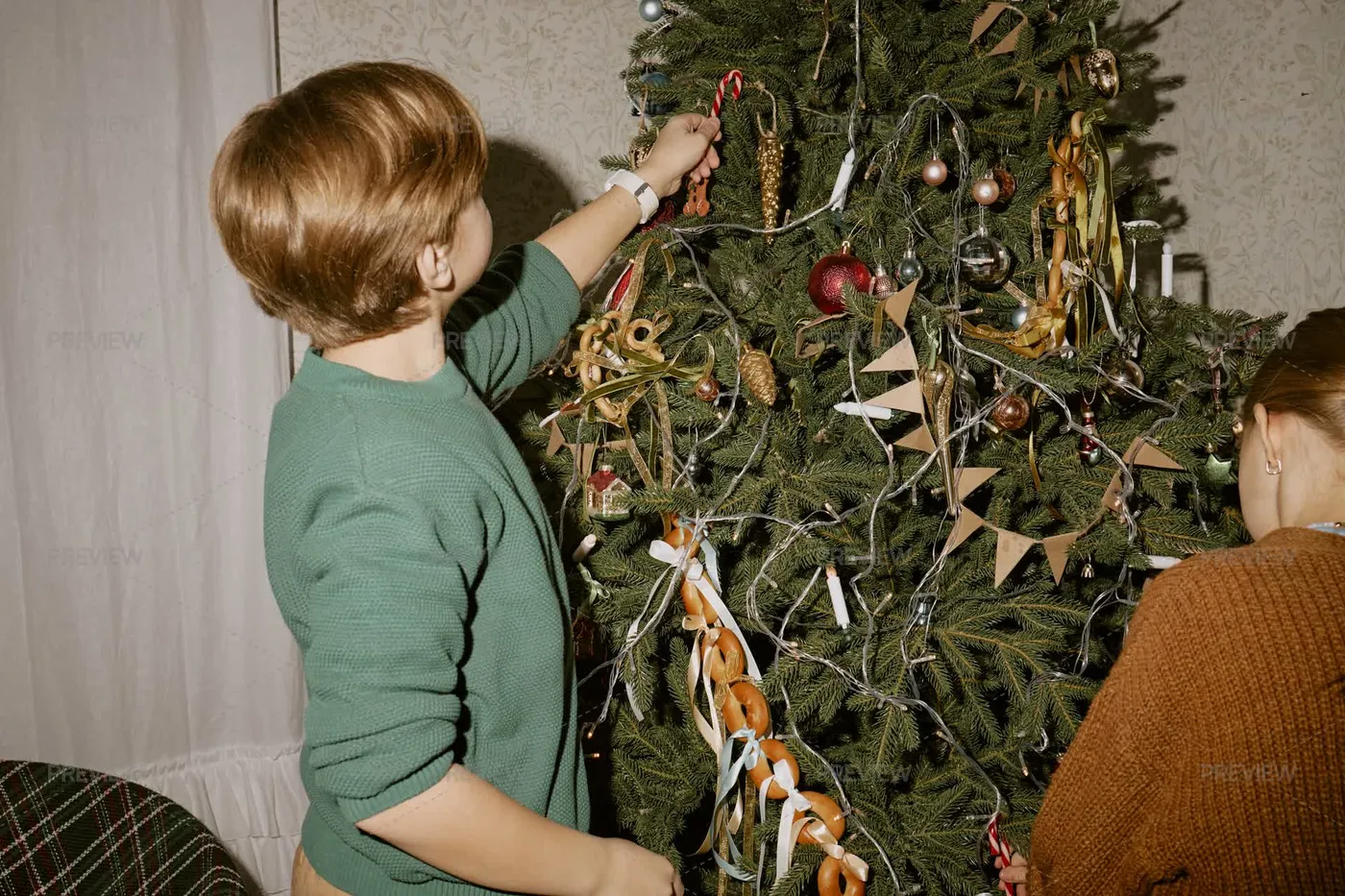 Children Decorating Christmas Tree With Ornaments During Holiday Season by  SeventyFour - Stock Photos | Motion Array