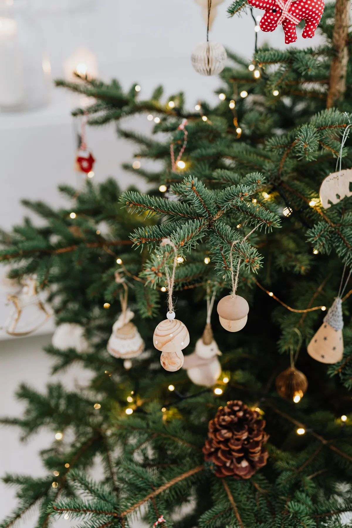 Close-up of a decorated Christmas tree with wooden ornaments and lights. Perfect holiday ambiance.