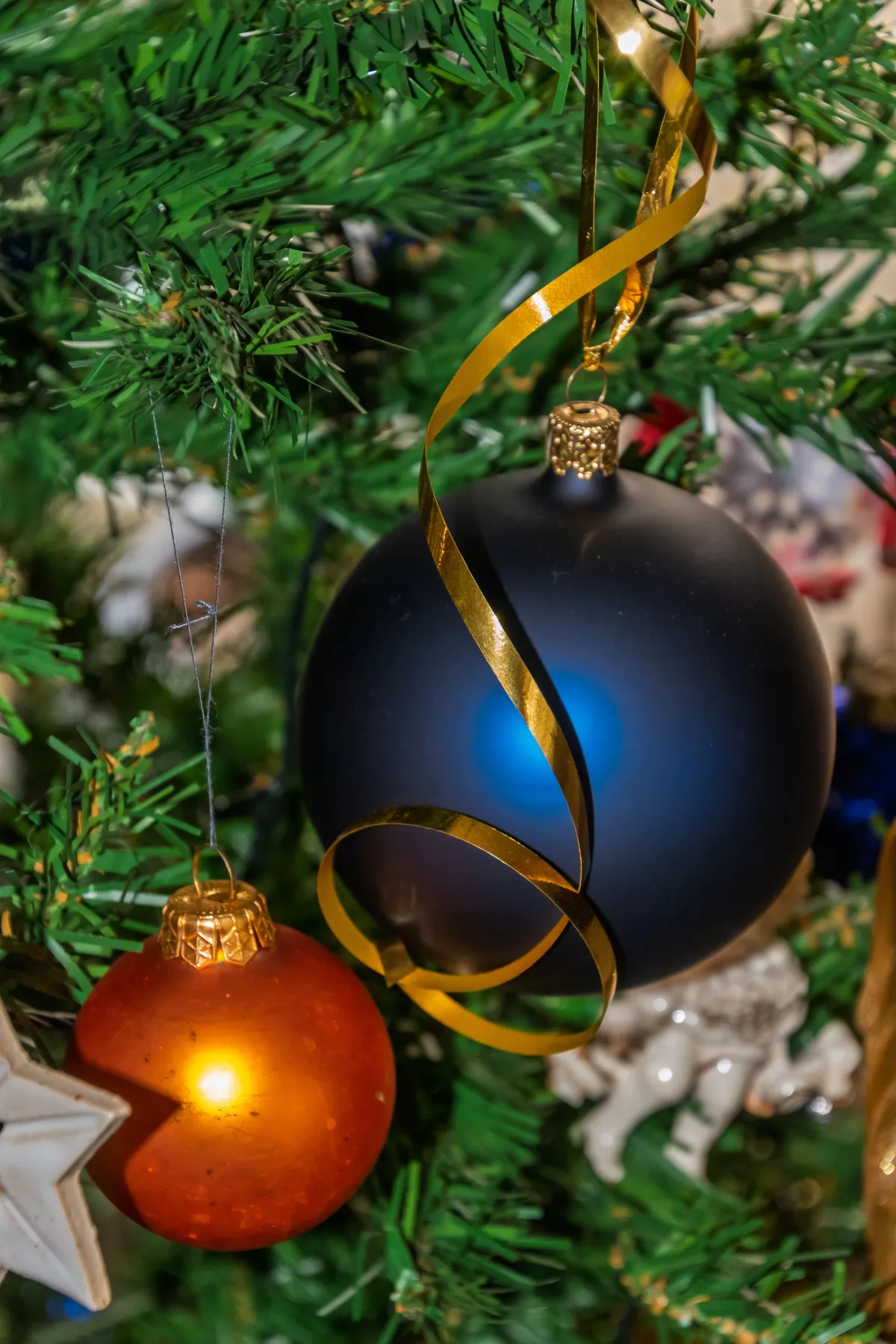 Close-up of colorful Christmas ornaments on a decorated tree