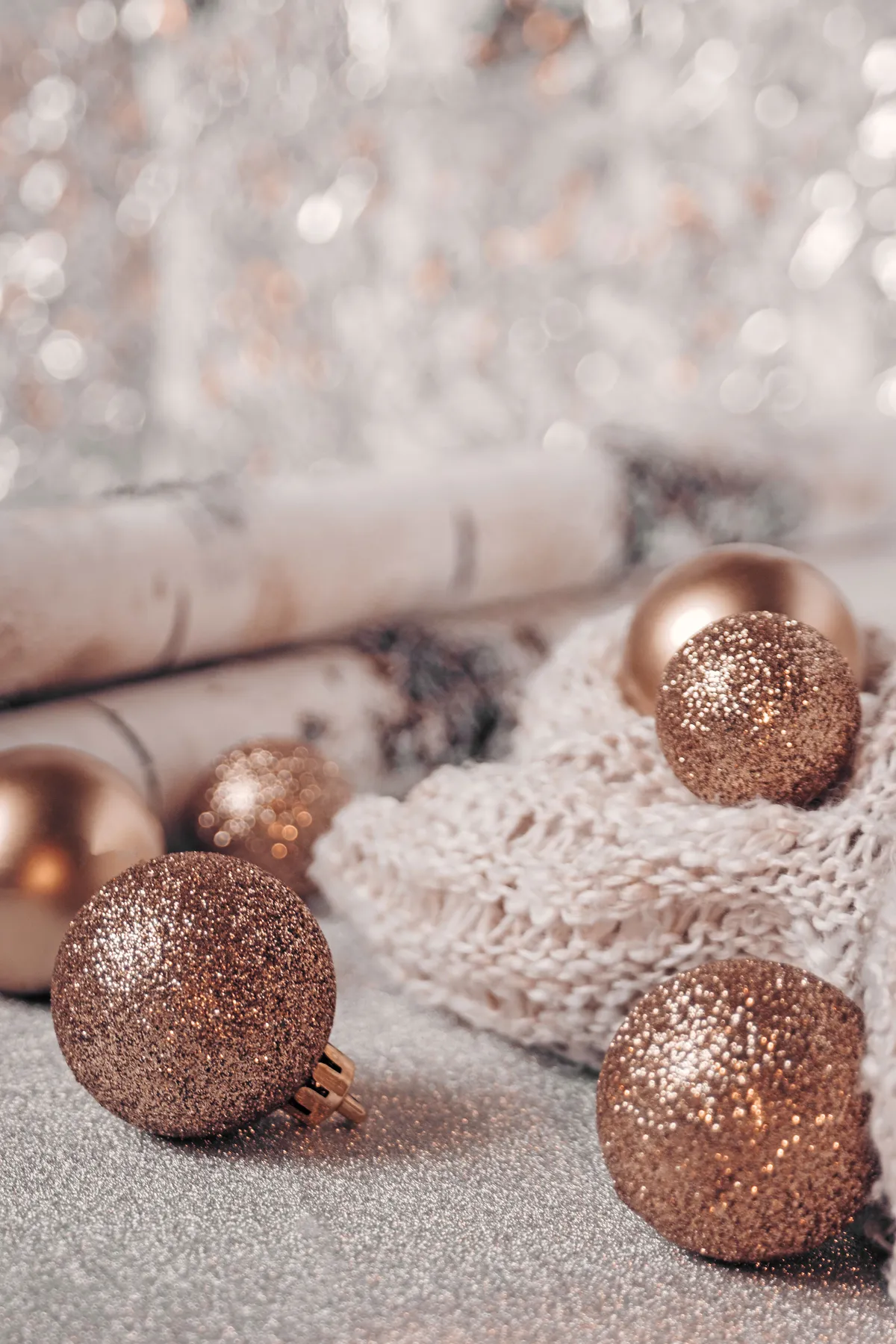 Close-up of glittery Christmas ornaments with a cozy winter ambiance.
