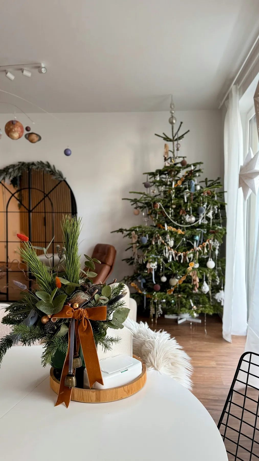 Decorated christmas tree and festive centerpiece on table