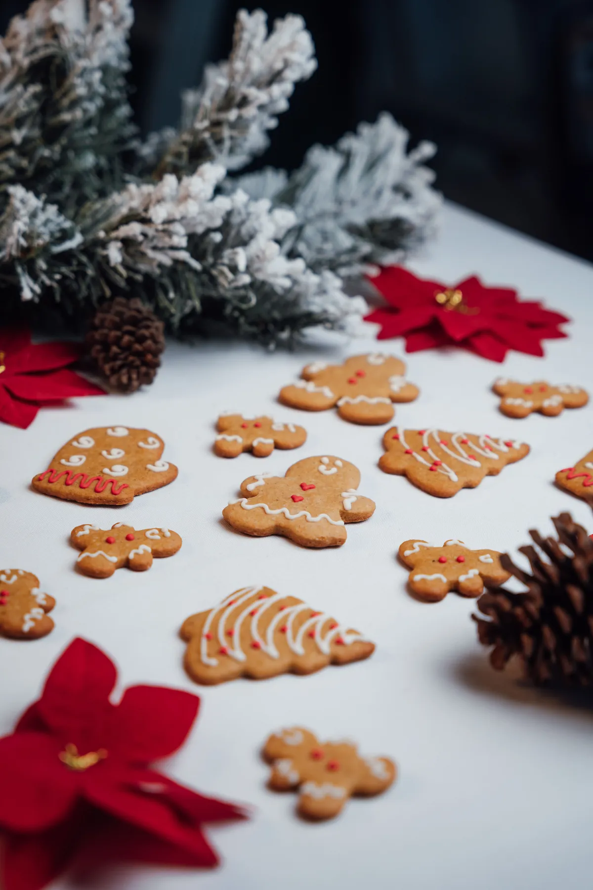 Delightful gingerbread cookies surrounded by festive decorations, perfect for the holiday season.