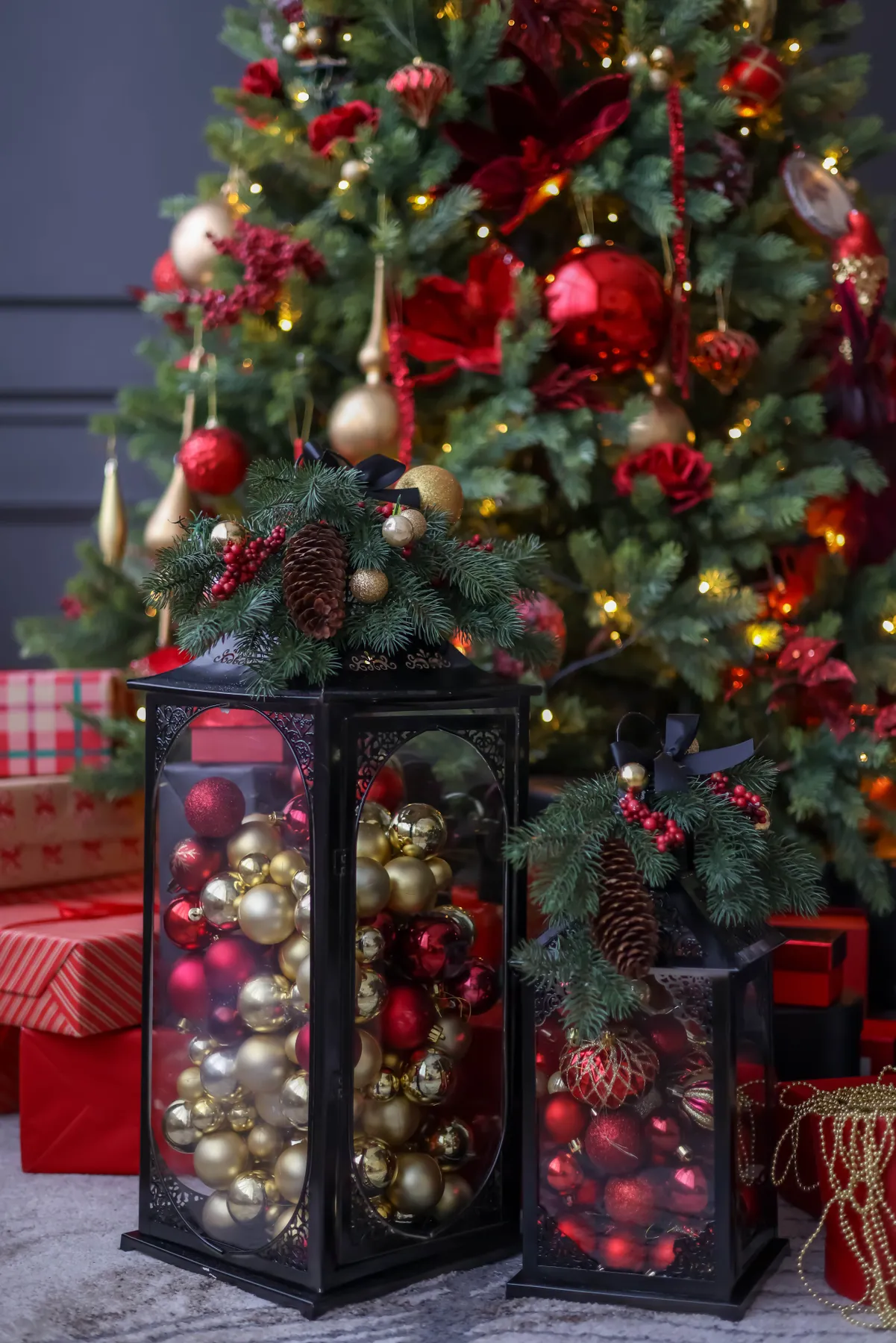 Elegant Christmas tree with gifts and decorative ornaments in festive colors.