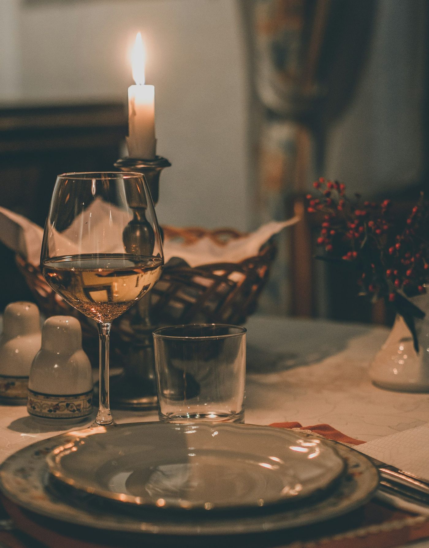 Festive table with candle, warm light, elegant decor