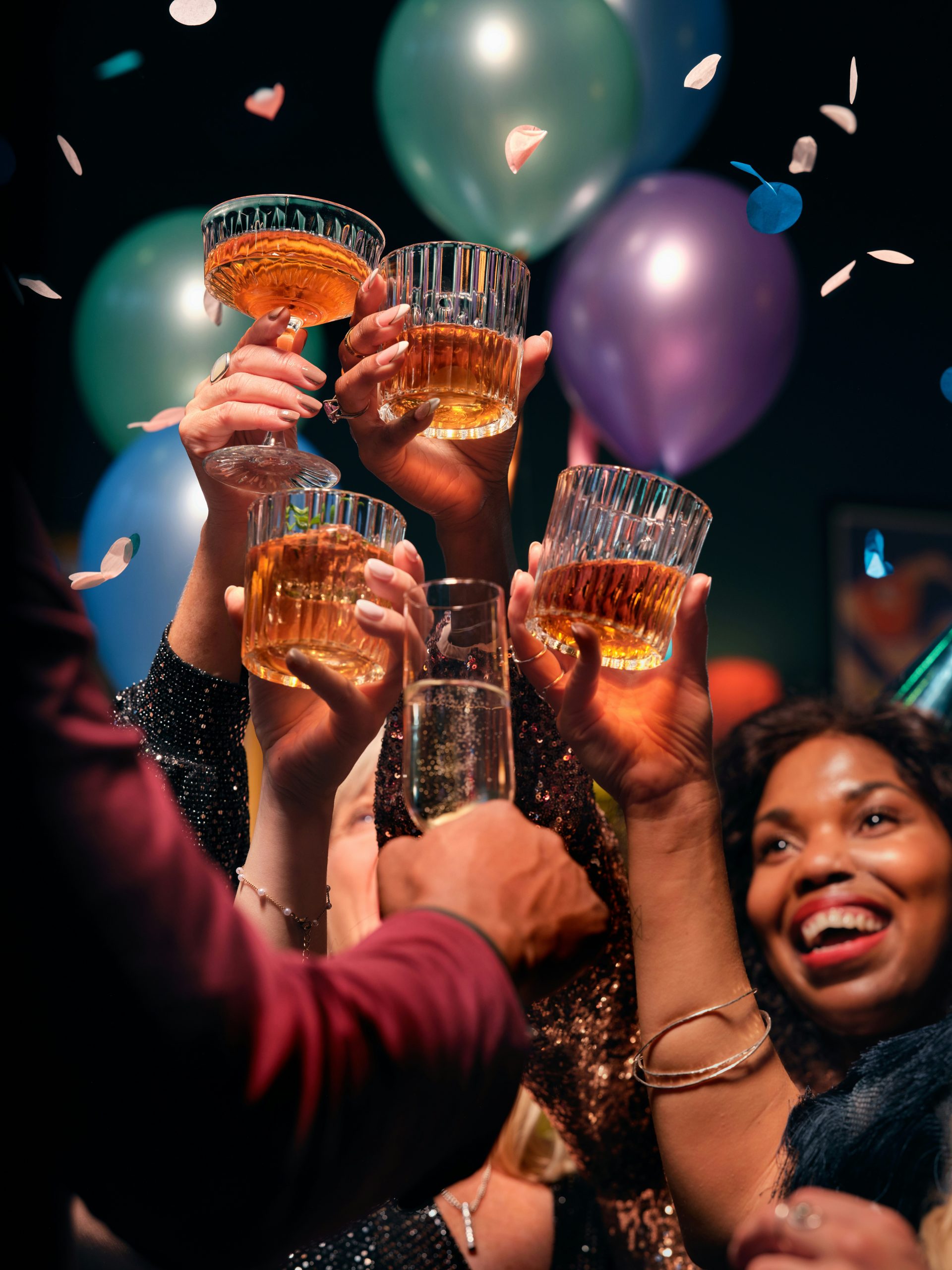 Friends drinking whisky and cocktails at a Christmas or New Years Eve party. This image is part of the OurWhisky Foundation’s Modern Face of Whisky library, designed to challenge gender bias and impro