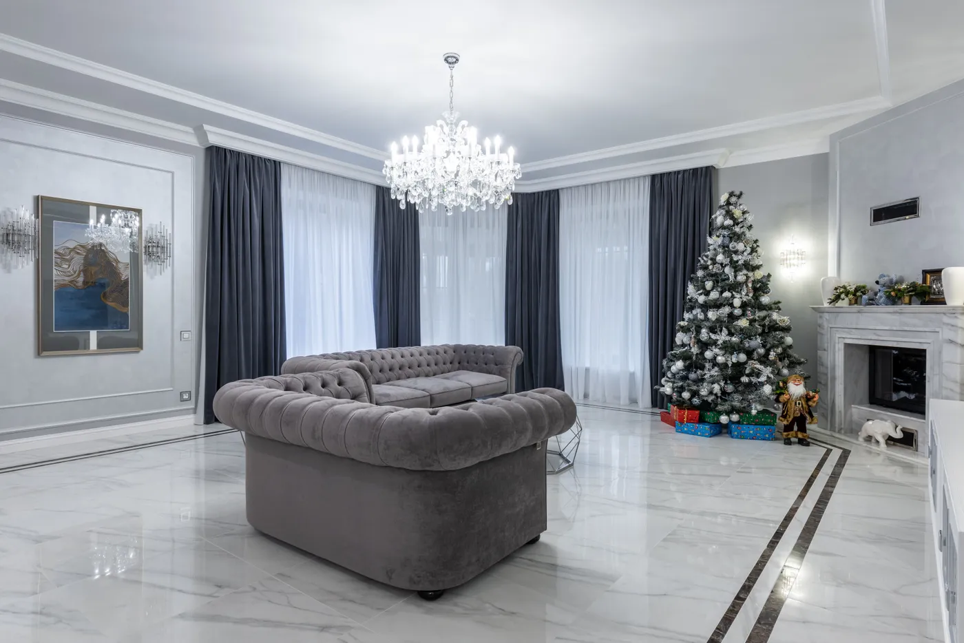 Interior of modern spacious living room with stylish expensive furniture and festive Christmas tree in daytime