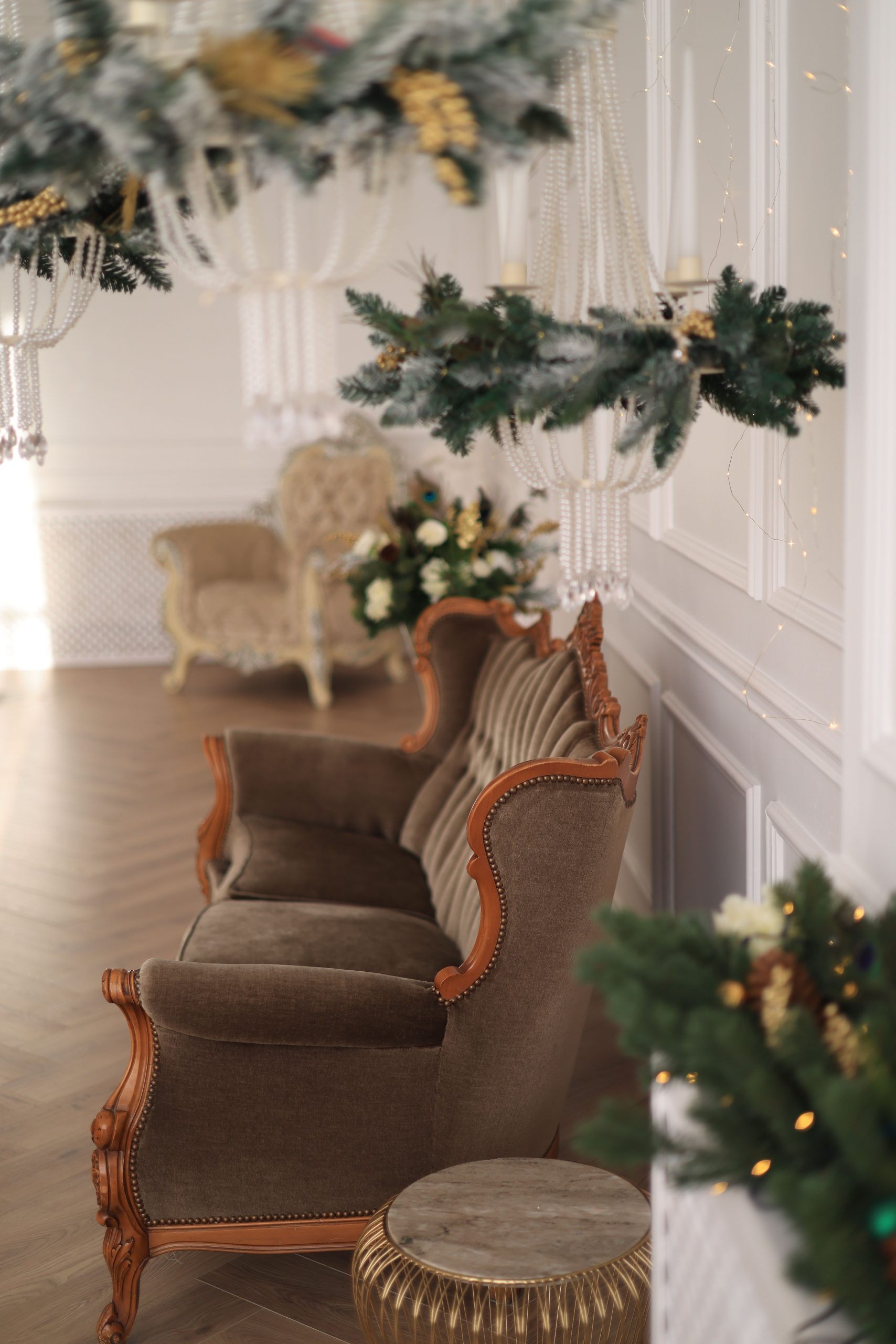 Luxurious living room adorned with festive Christmas decorations and classic furniture.