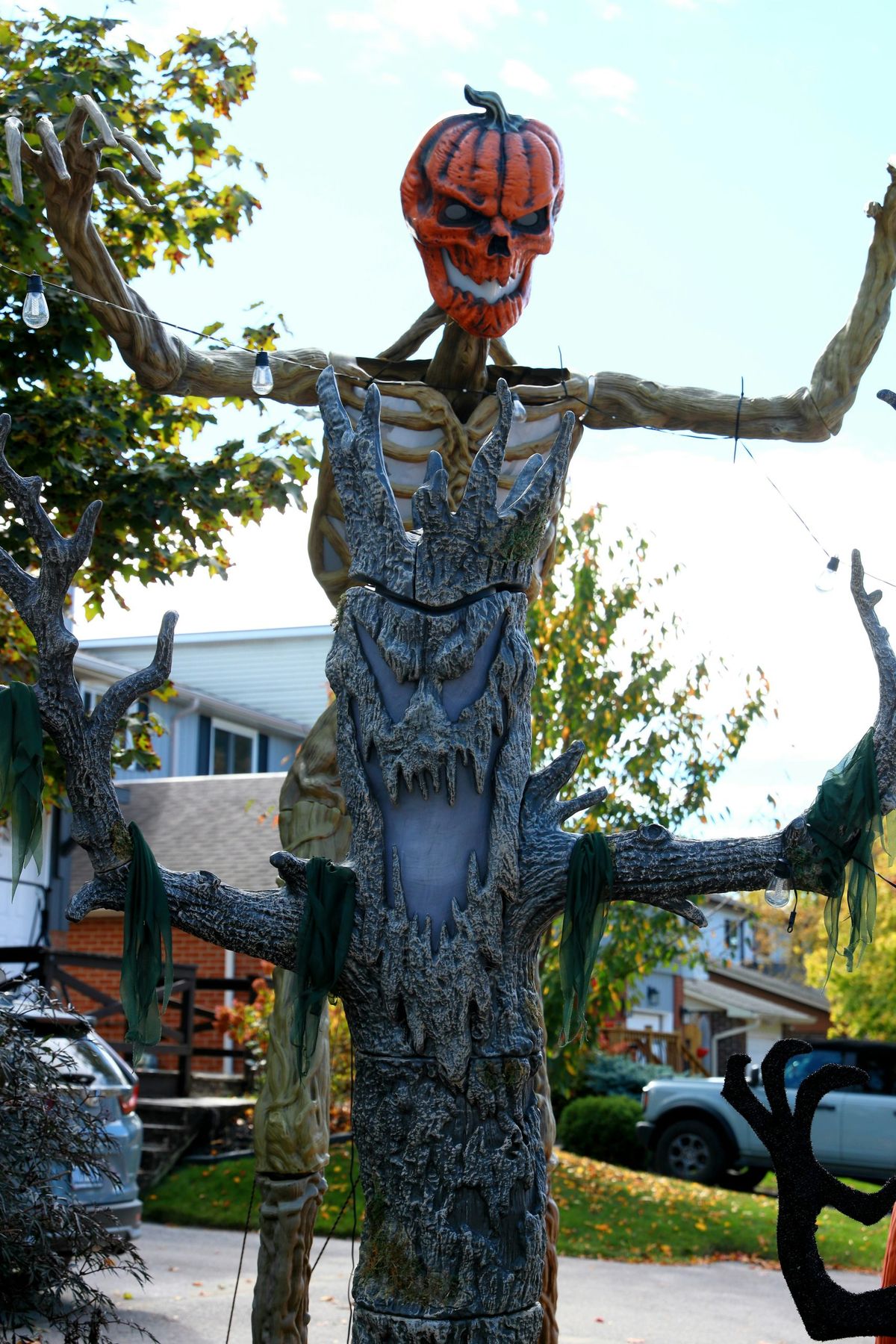Scary halloween decoration with pumpkin head and tree body