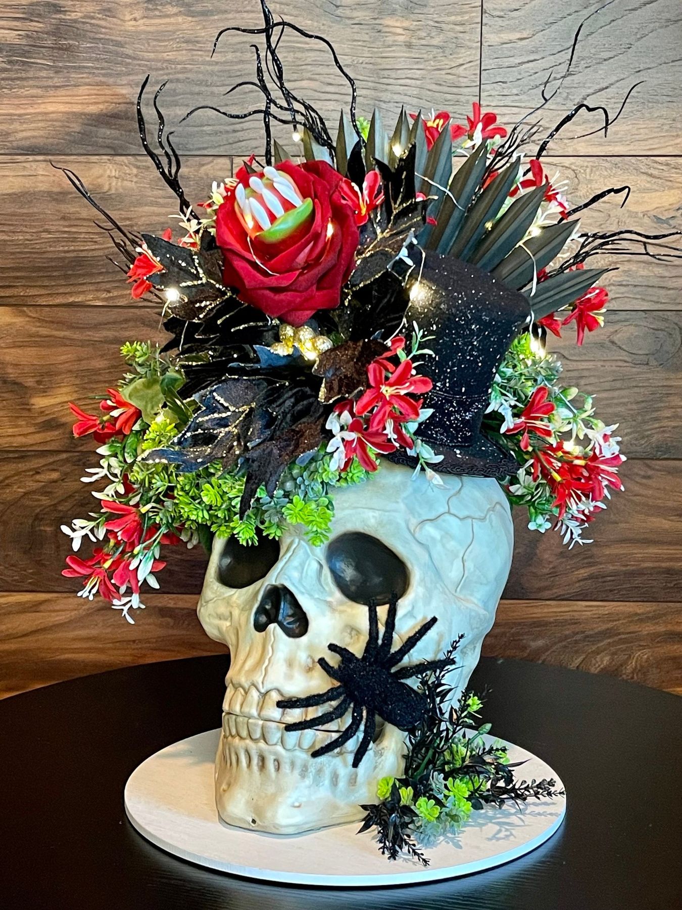 Skull Halloween centerpiece with pumpkins flowers and embellishments