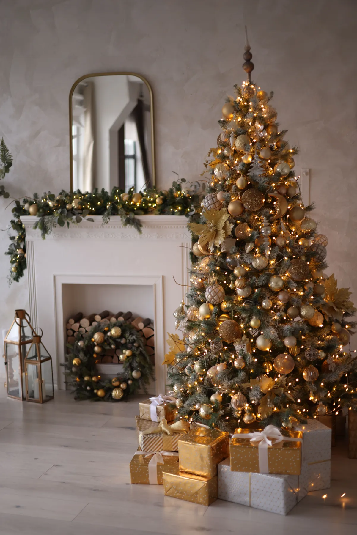 Warm and festive living room with a beautifully decorated Christmas tree and gifts by the fireplace.