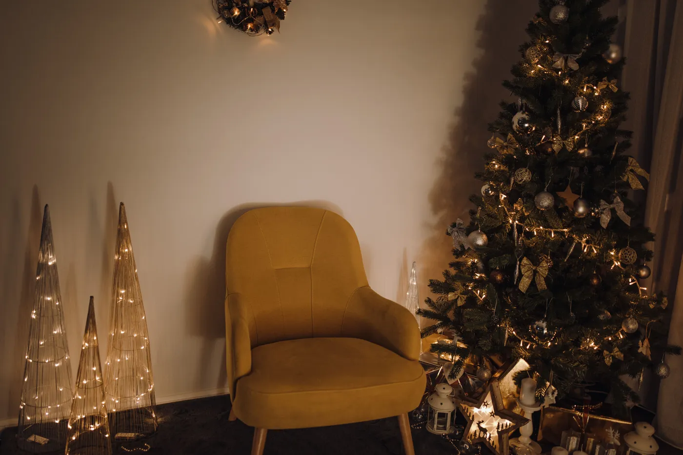 Warm and festive living room with a decorated Christmas tree and cozy chair.