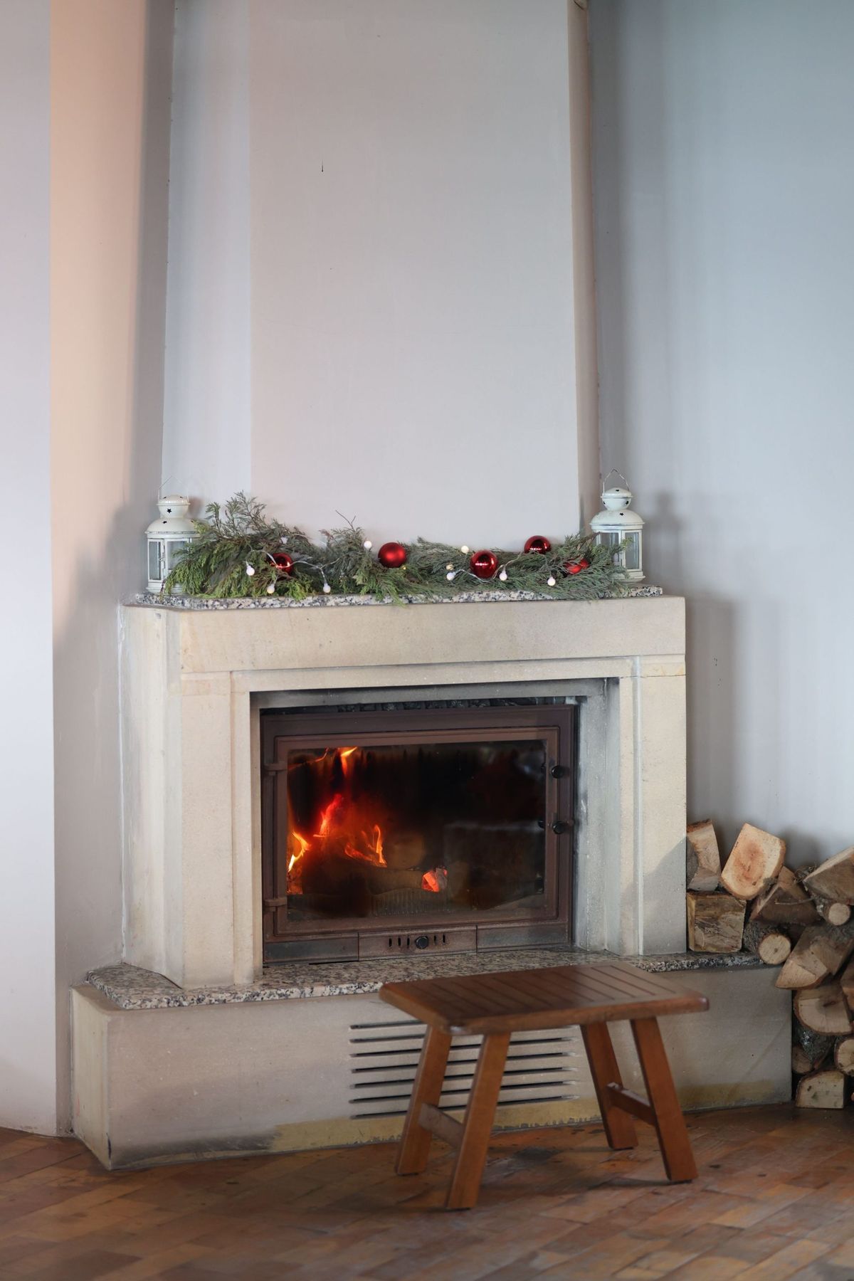 Warm indoor fireplace decorated for the holidays, creating a festive atmosphere.