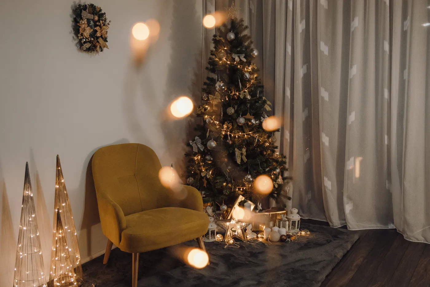Warm living room featuring a decorated Christmas tree and festive lighting.