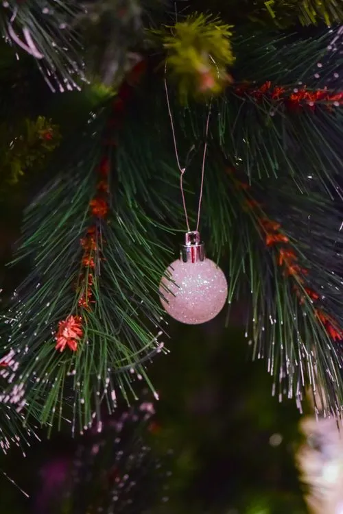 White Christmas decoration hanging on Christmas tree · Free Stock Photo